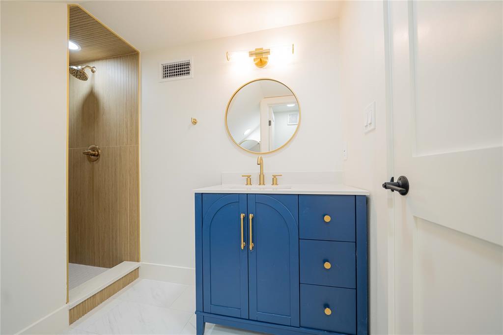 644 North Private Road Leesburg, TX 75451 - Photo 26 of 40 a bathroom with a sink a mirror and a shower