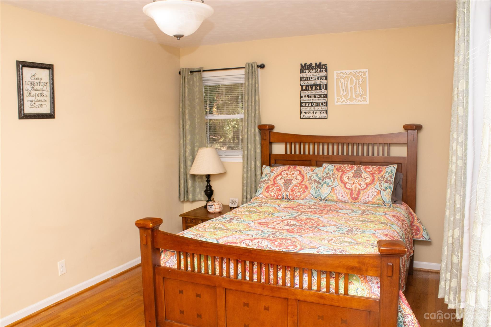 1030 Martin Road Hickory Grove, SC 29717 - Photo 18 of 22 a bed sitting in a bedroom next to a window