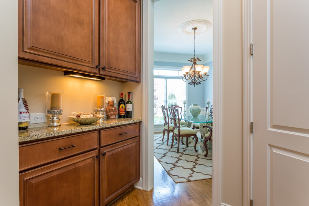 Granite counter top, rich wood cabinets, and a pantry on the right. Just large enough to properly separate the formal dining room from the kitchen, or allow preparation of mixed drinks near the table. Install a wine cooler? The choice is yours! Butler's Pantry