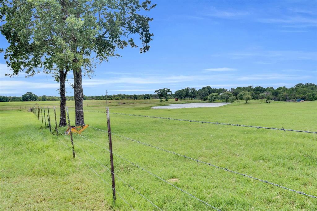 1467 Brown Road Palo Pinto, TX 76484 - Photo 12 of 38 a view of a golf course with a lake