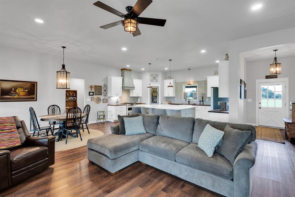 1467 Brown Road Palo Pinto, TX 76484 - Photo 18 of 38 a living room with furniture kitchen view and a wooden floor