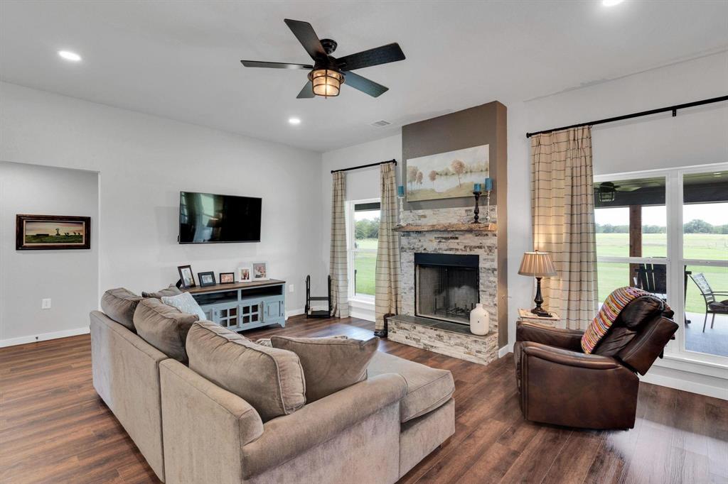 1467 Brown Road Palo Pinto, TX 76484 - Photo 19 of 38 a living room with furniture a flat screen tv and a fireplace