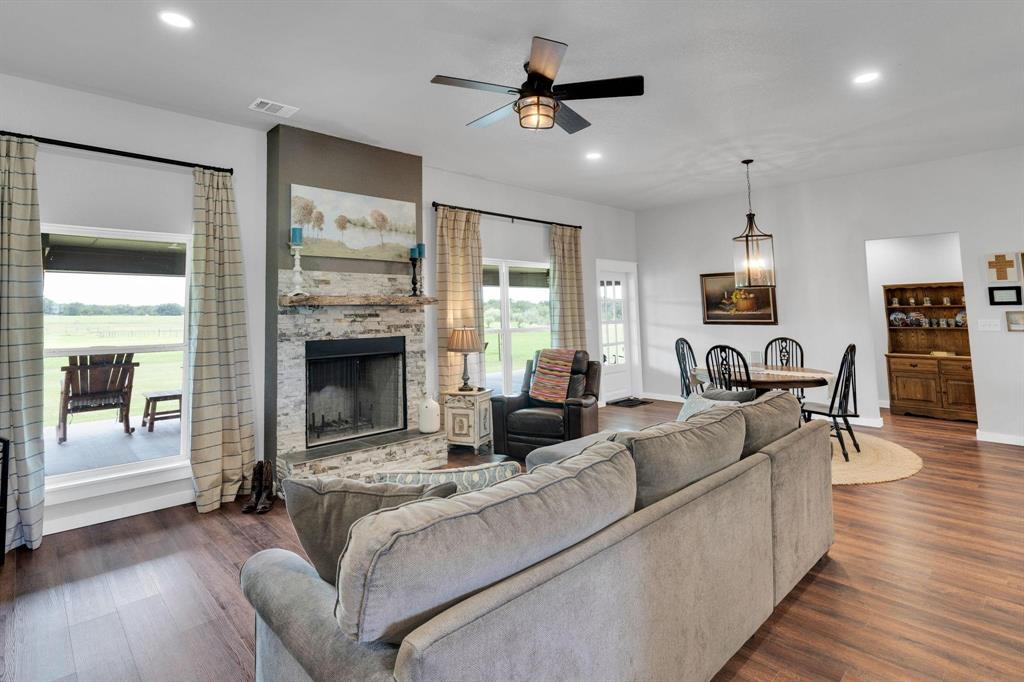 1467 Brown Road Palo Pinto, TX 76484 - Photo 20 of 38 a living room with furniture fireplace and wooden floor