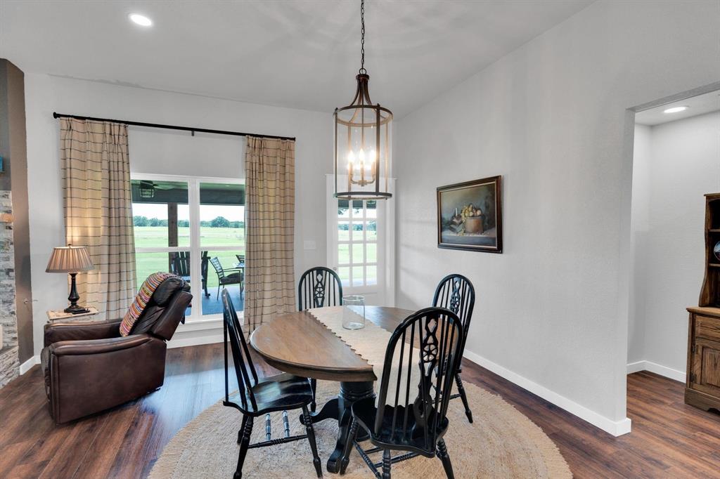 1467 Brown Road Palo Pinto, TX 76484 - Photo 21 of 38 a view of a dining room with furniture window and wooden floor