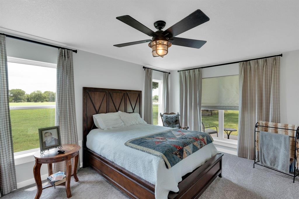 1467 Brown Road Palo Pinto, TX 76484 - Photo 29 of 38 a bedroom with a bed and a large window