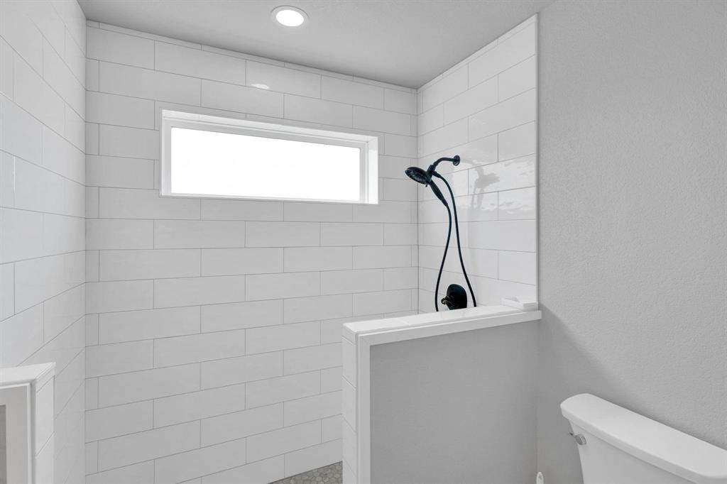 1467 Brown Road Palo Pinto, TX 76484 - Photo 30 of 38 a bathroom with a sink a toilet and a window
