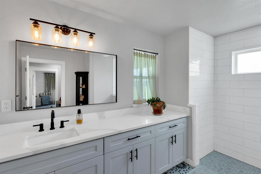 1467 Brown Road Palo Pinto, TX 76484 - Photo 31 of 38 a bathroom with a sink and a mirror