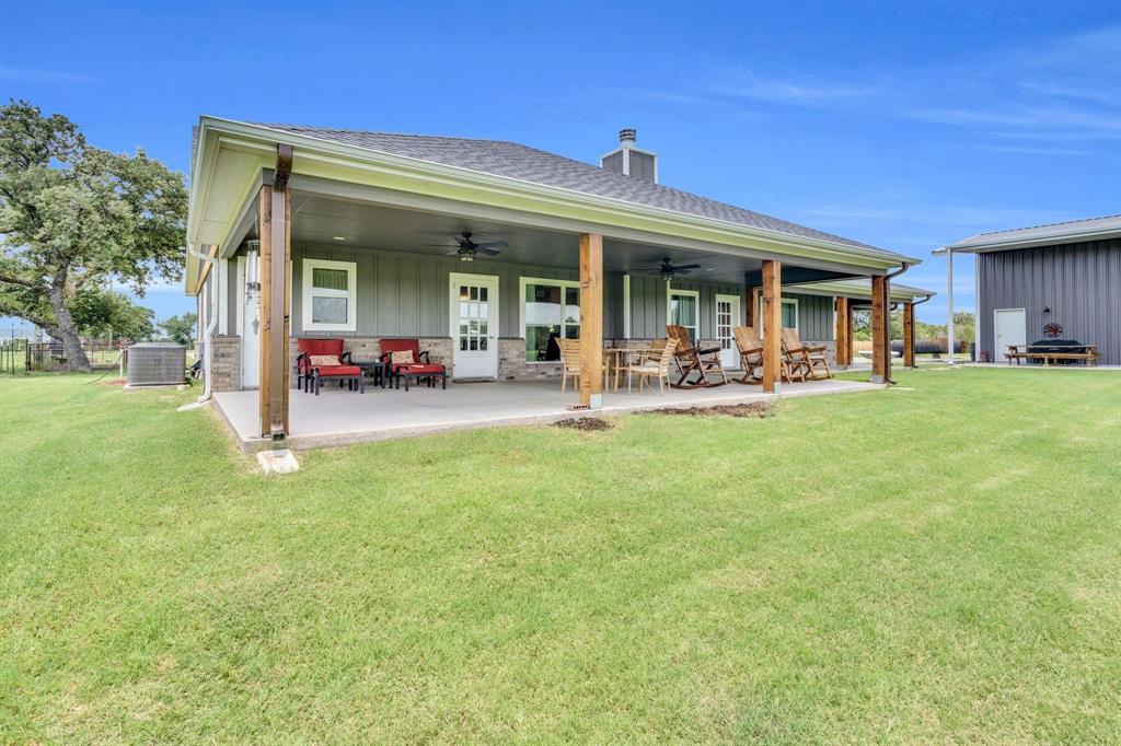 1467 Brown Road Palo Pinto, TX 76484 - Photo 7 of 38 a view of a house with a backyard porch and sitting area