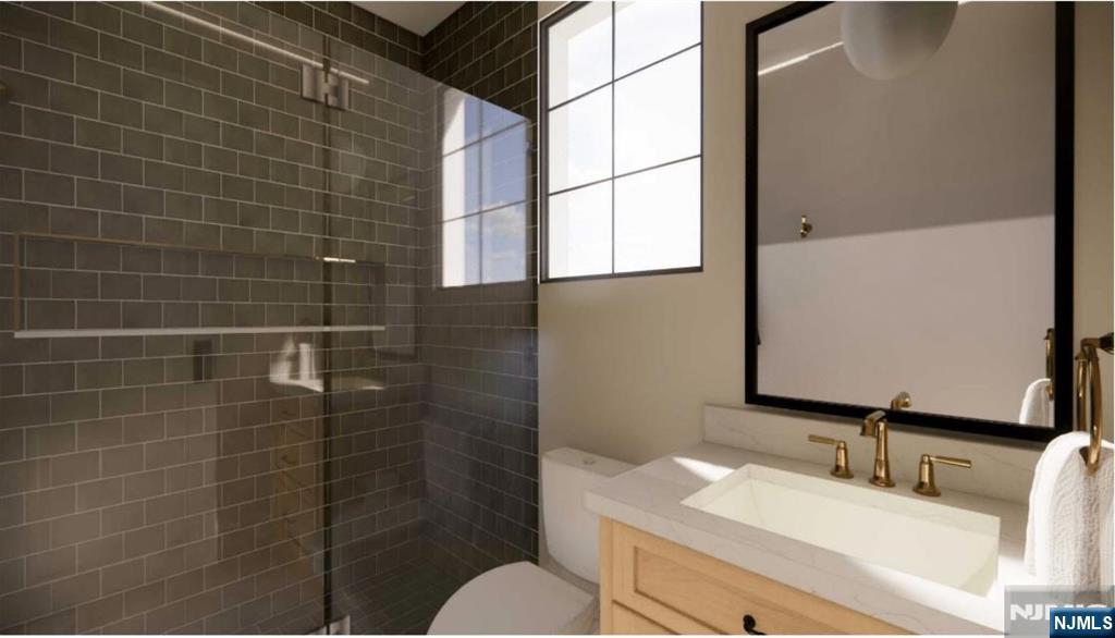 331 Lockwood Drive Paramus, NJ 07652 - Photo 23 of 33 a bathroom with a granite countertop sink a toilet and mirror