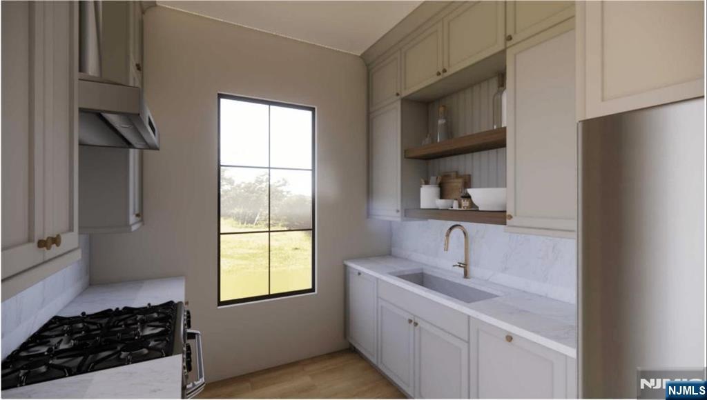 331 Lockwood Drive Paramus, NJ 07652 - Photo 29 of 33 a kitchen with a sink stove and cabinets