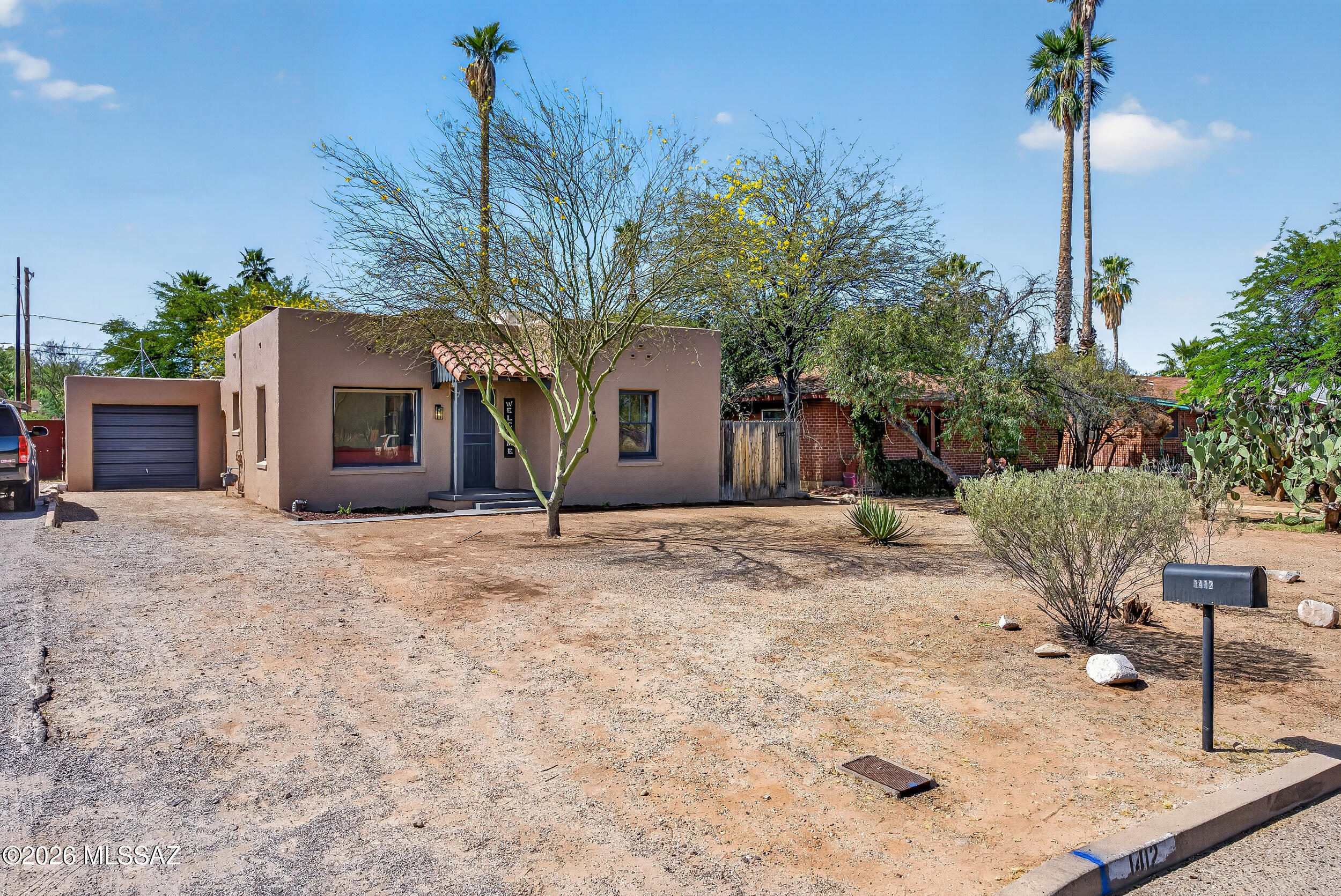 1412 East Spring Street Tucson, AZ 85719 - Photo 10 of 43 a front view of a house with a yard and garage