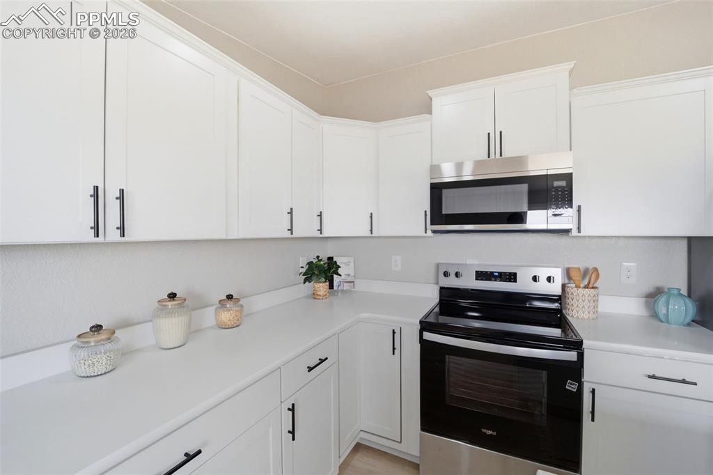 35125 Book Road Yoder, CO 80864 - Photo 25 of 45 a kitchen with stainless steel appliances white cabinets and a sink