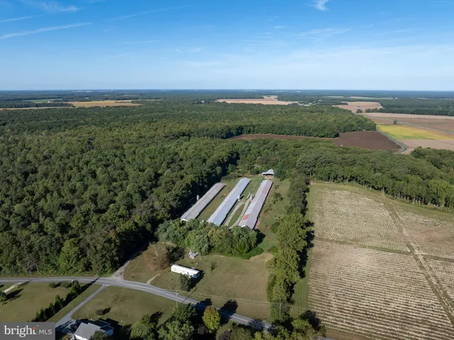an aerial view of a residential houses with outdoor space and street view