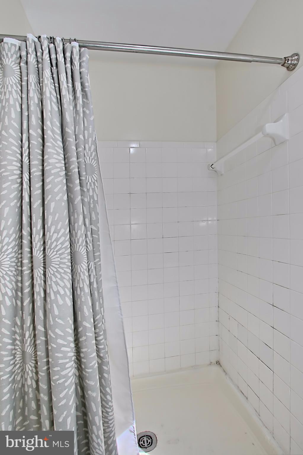 7705 Lexton Place, Unit C Springfield, VA 22152 - Photo 18 of 29 Spa-toned tiled walk-in shower