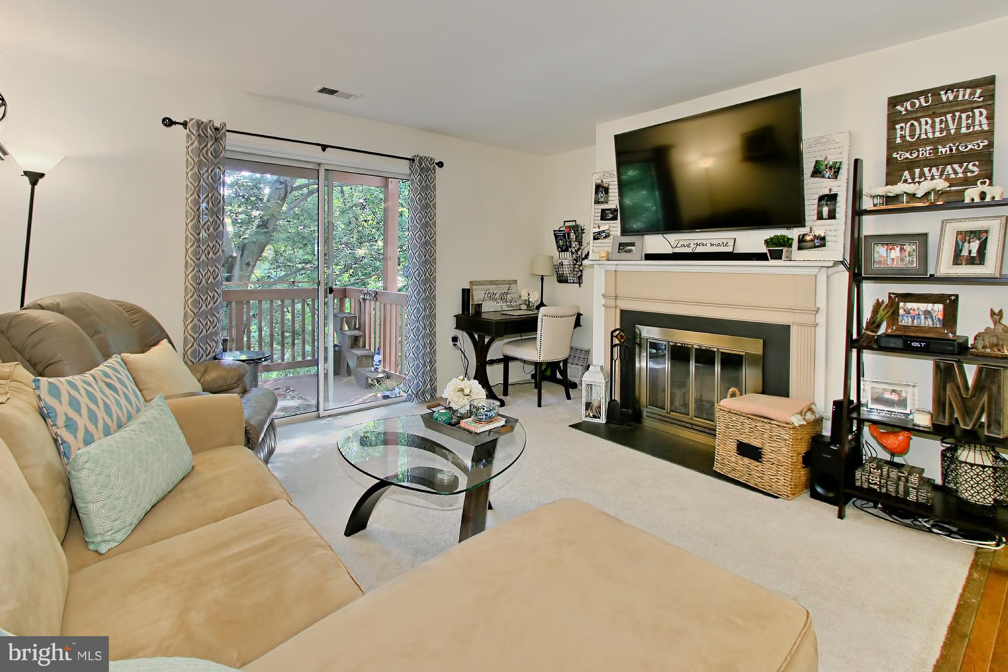 7705 Lexton Place, Unit C Springfield, VA 22152 - Photo 8 of 29 Cozy wood-burning fireplace focal point