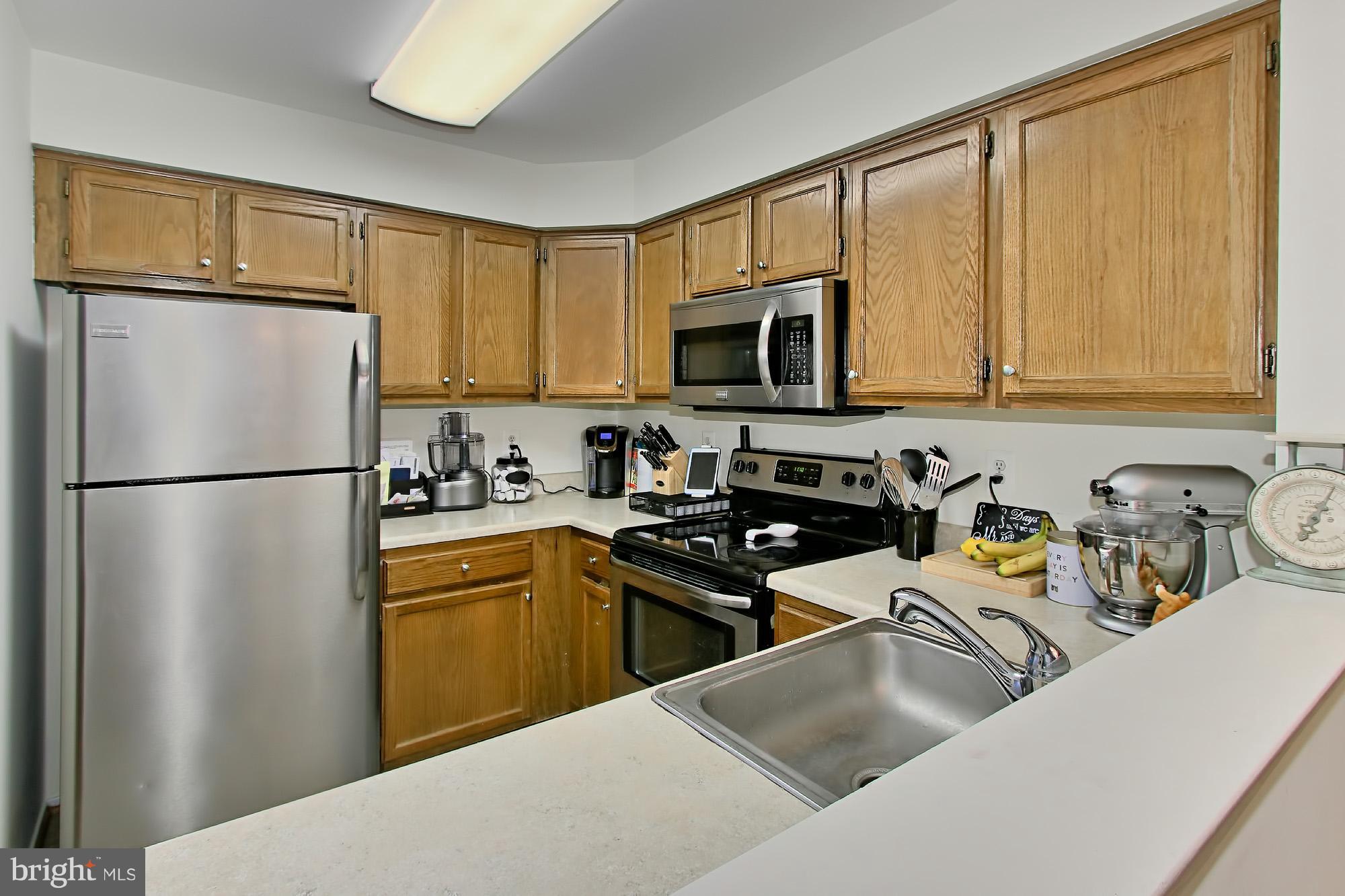 7705 Lexton Place, Unit C Springfield, VA 22152 - Photo 10 of 29 Kitchen pass through creates an airy atmosphere
