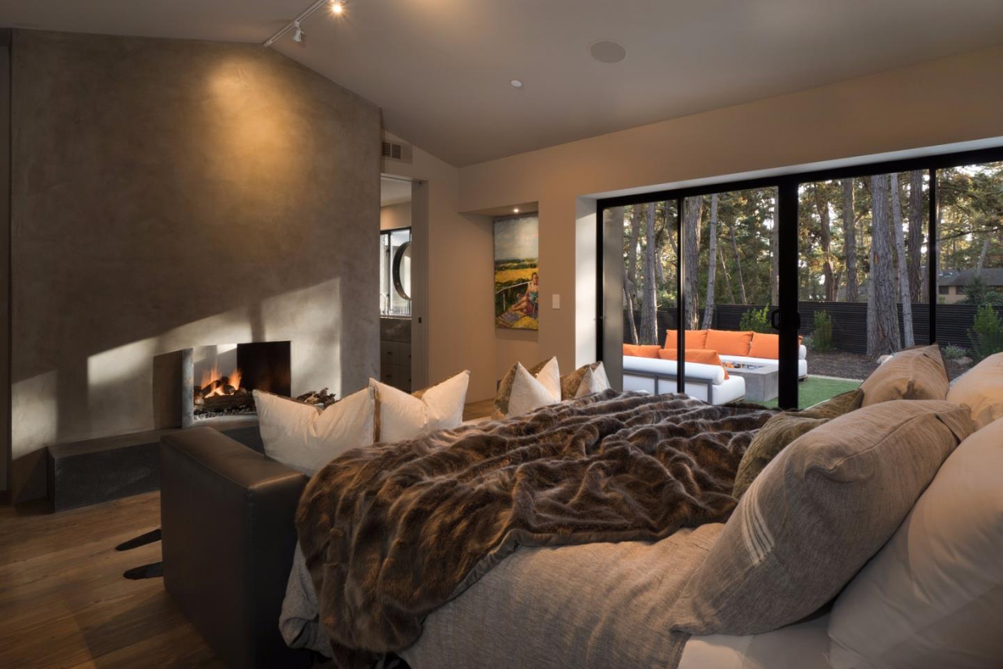 4064 Ronda Road Pebble Beach, CA 93953 - Photo 11 of 19 a bedroom with a bed and glass window