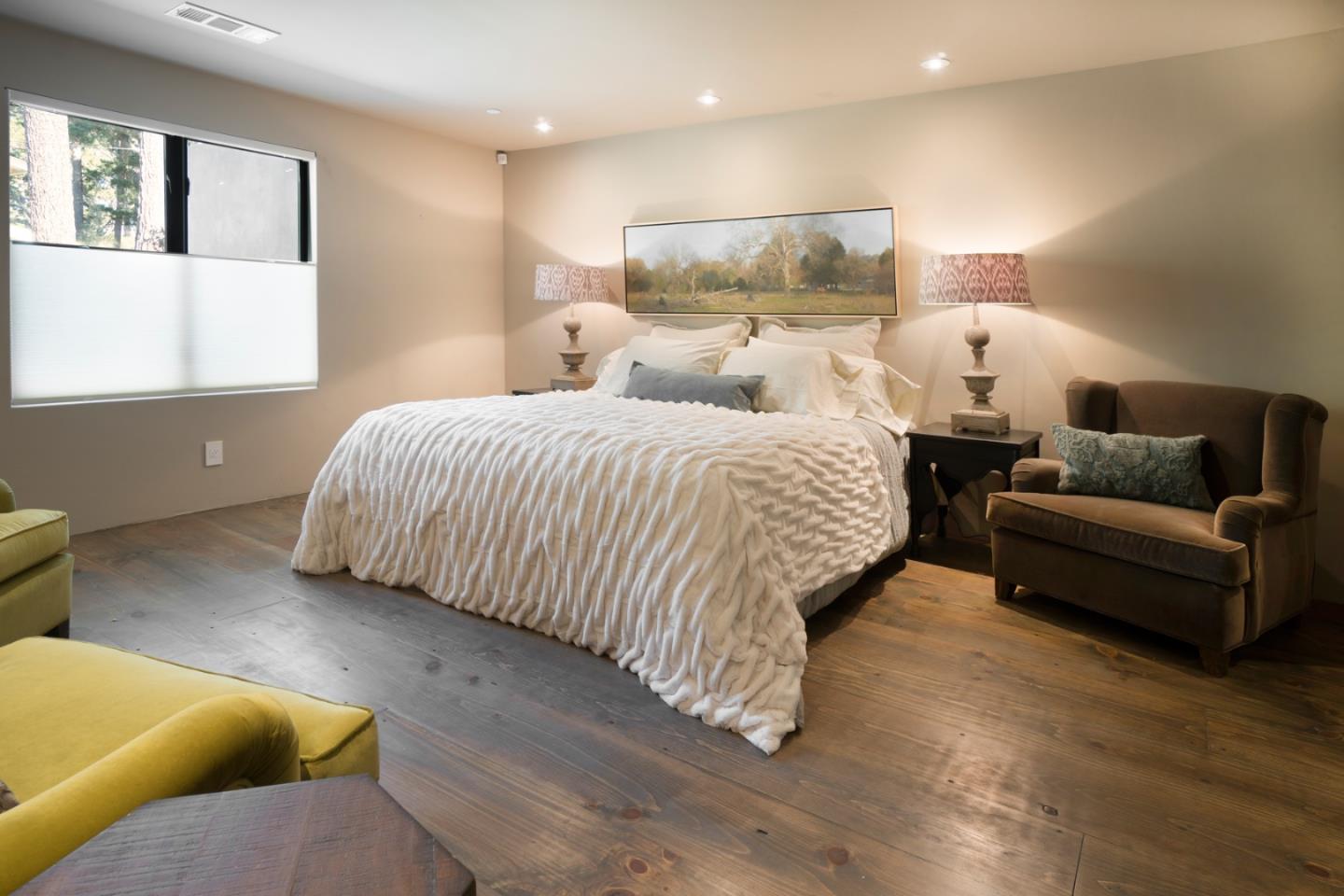 4064 Ronda Road Pebble Beach, CA 93953 - Photo 16 of 19 a spacious bedroom with a bed and glass window