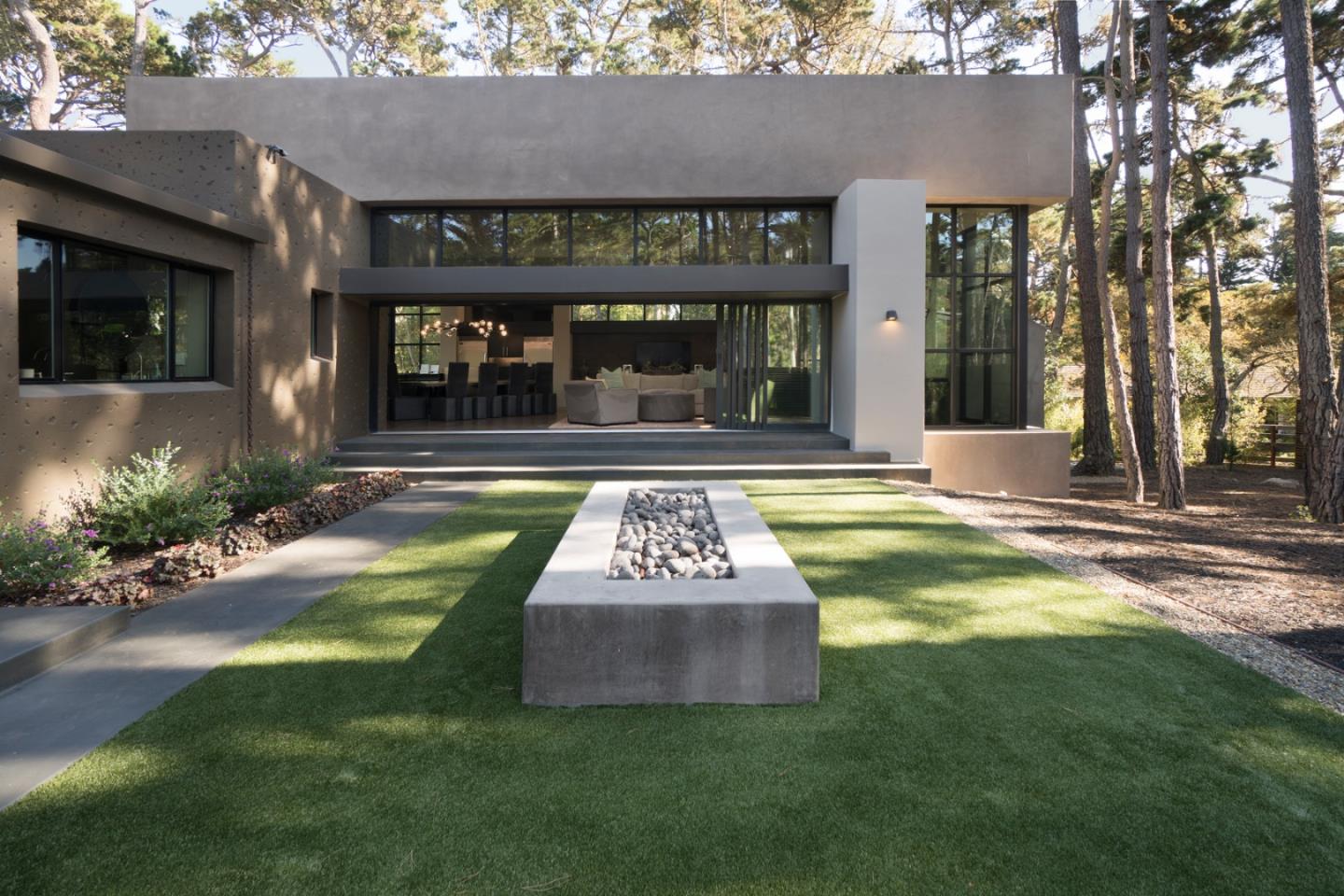 4064 Ronda Road Pebble Beach, CA 93953 - Photo 17 of 19 a front view of a building with play ground and large tree