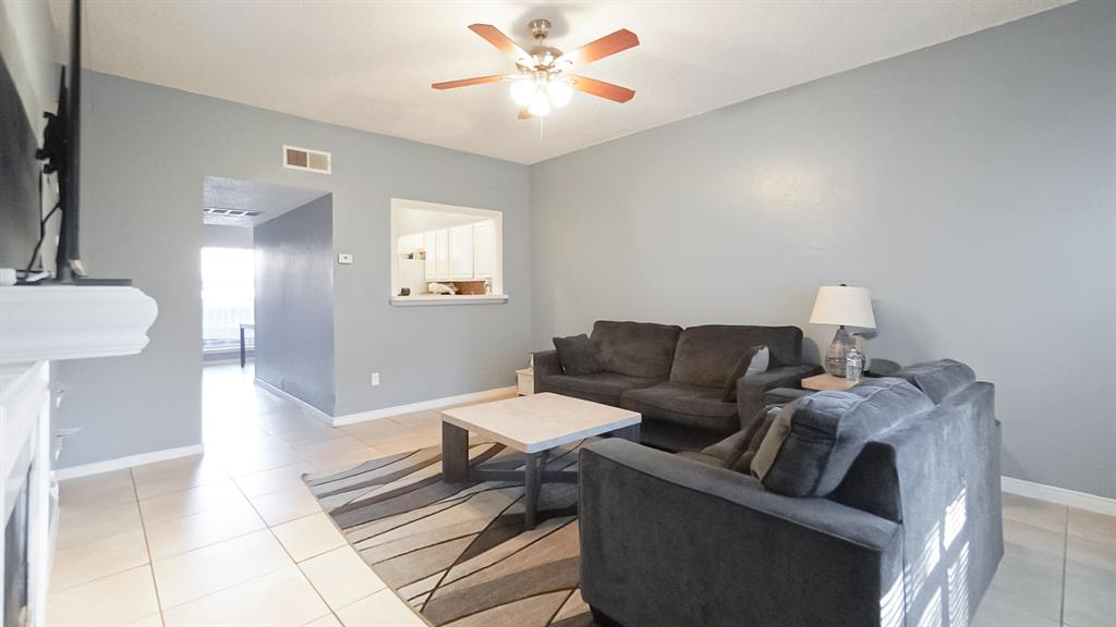 12921 Abrams Road, Unit 505 Dallas, TX 75243 - Photo 7 of 24 Living area with light tile patterned floors and a ceiling fan