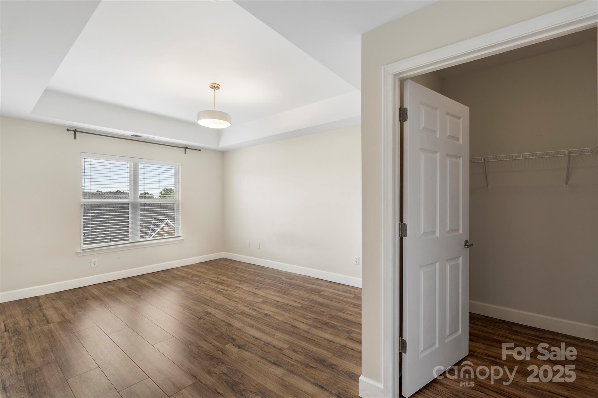 3805 Balsam Street, Unit 321 Indian Trail, NC 28079 - Photo 15 of 47 a view of an empty room with wooden floor and a window