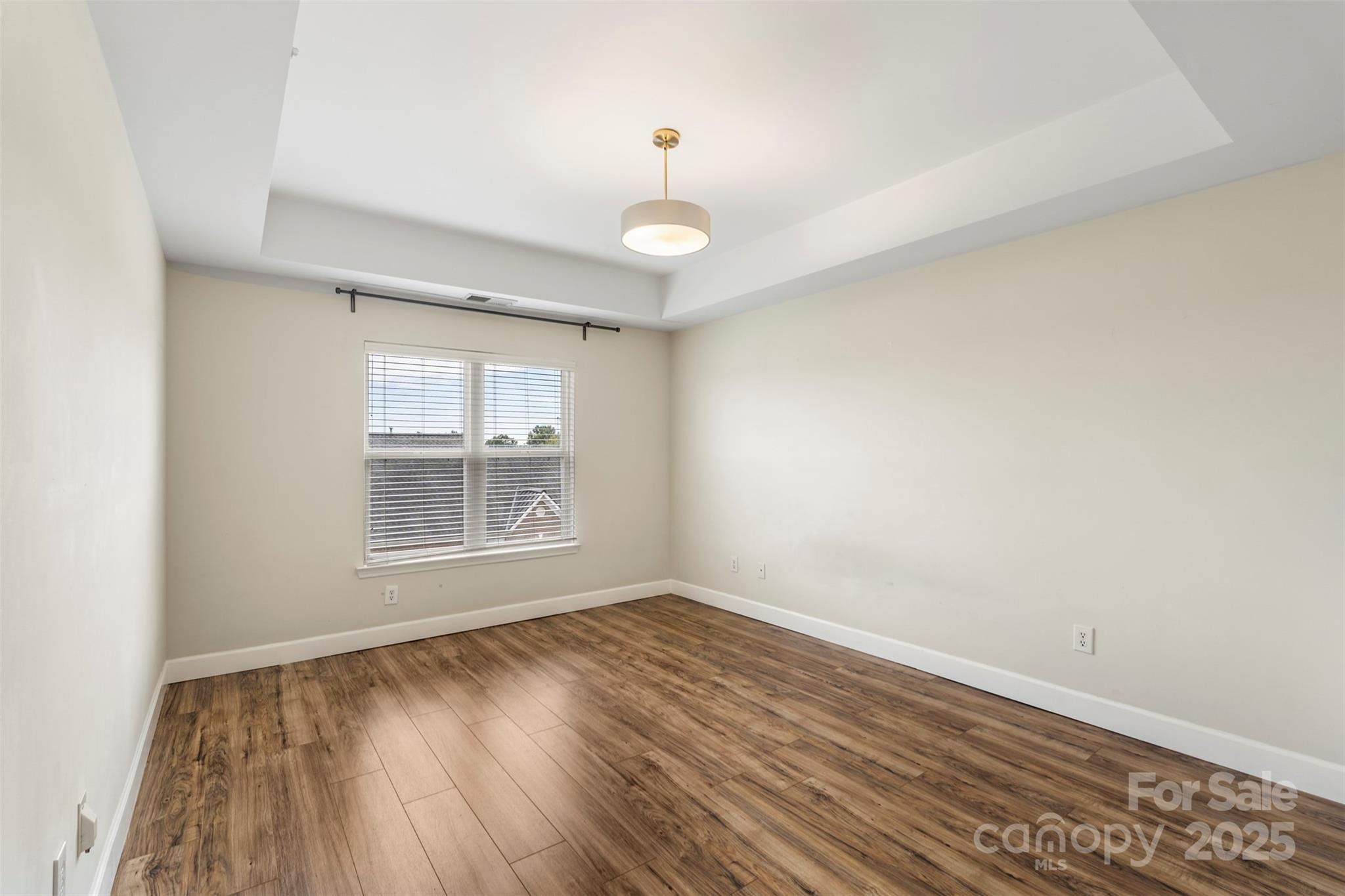 3805 Balsam Street, Unit 321 Indian Trail, NC 28079 - Photo 16 of 47 an empty room with wooden floor and windows