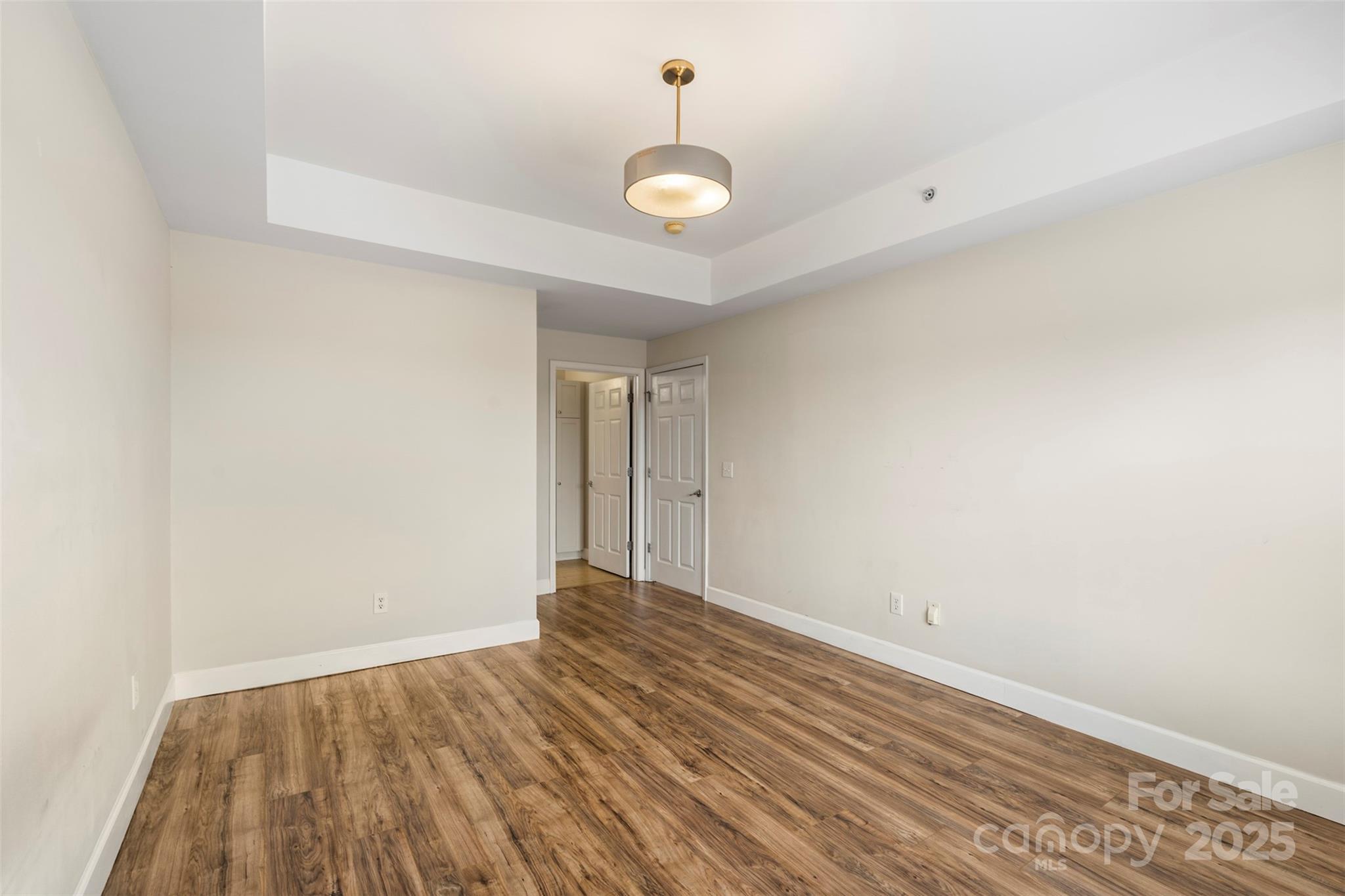 3805 Balsam Street, Unit 321 Indian Trail, NC 28079 - Photo 17 of 47 a view of a room with wooden floor and a ceiling fan