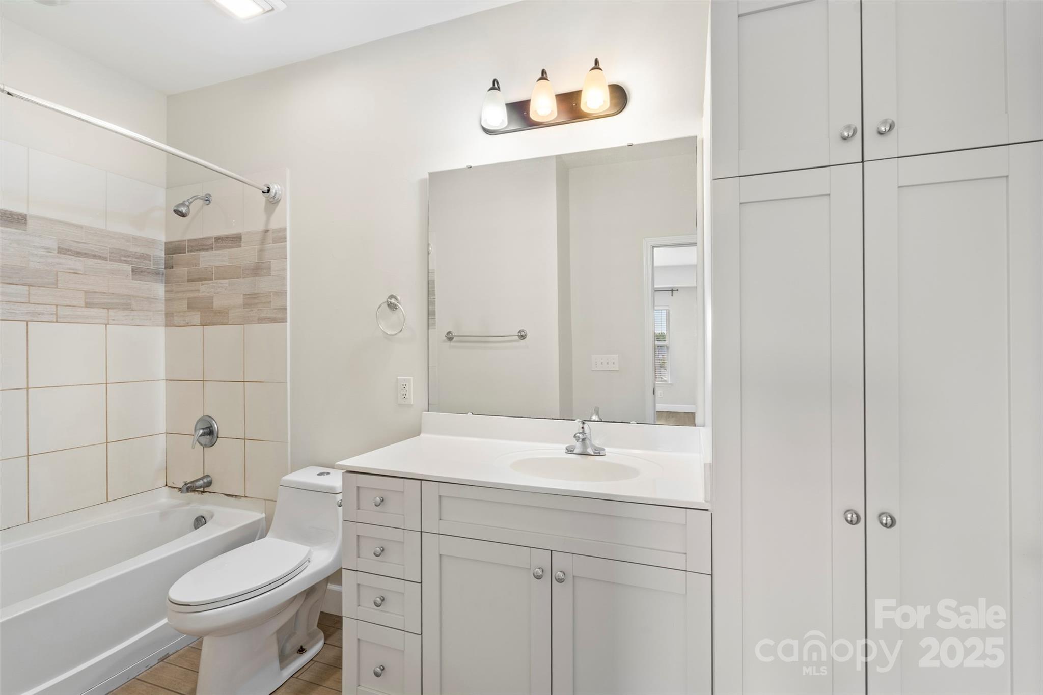 3805 Balsam Street, Unit 321 Indian Trail, NC 28079 - Photo 19 of 47 a bathroom with a sink toilet a mirror and shower