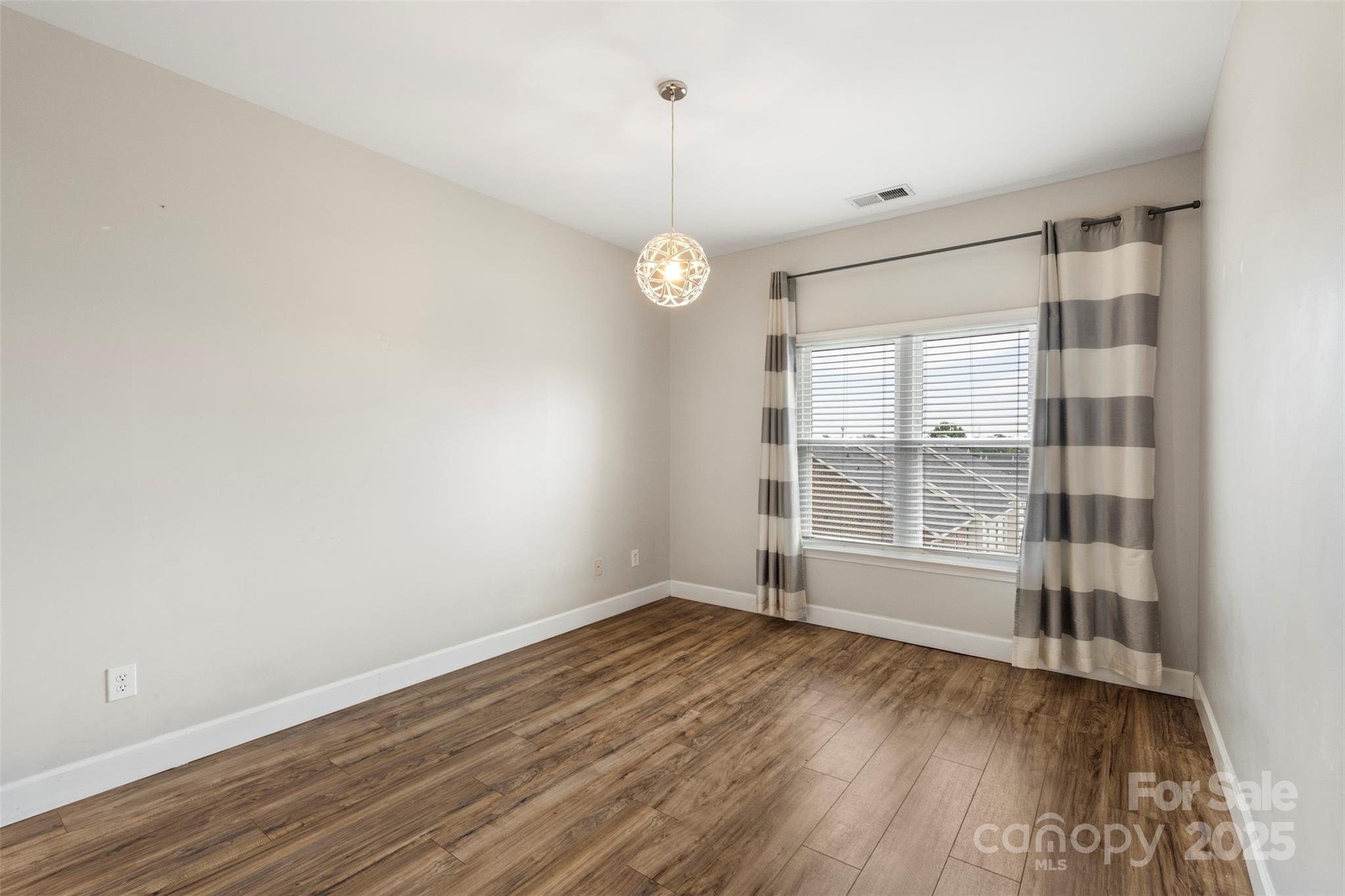 3805 Balsam Street, Unit 321 Indian Trail, NC 28079 - Photo 22 of 47 a view of an empty room with wooden floor and a window