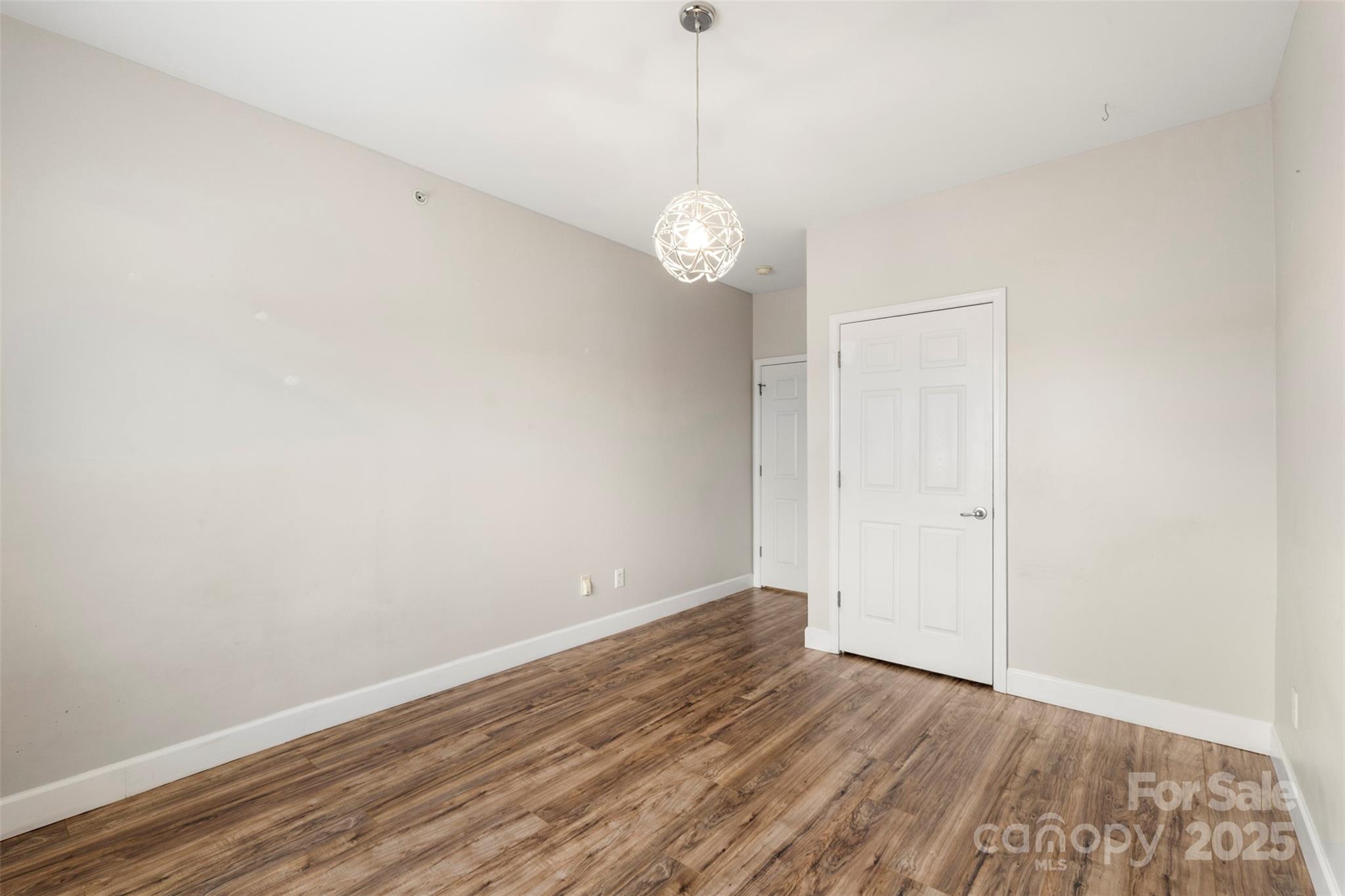 3805 Balsam Street, Unit 321 Indian Trail, NC 28079 - Photo 23 of 47 a view of a room with wooden floor and white walls