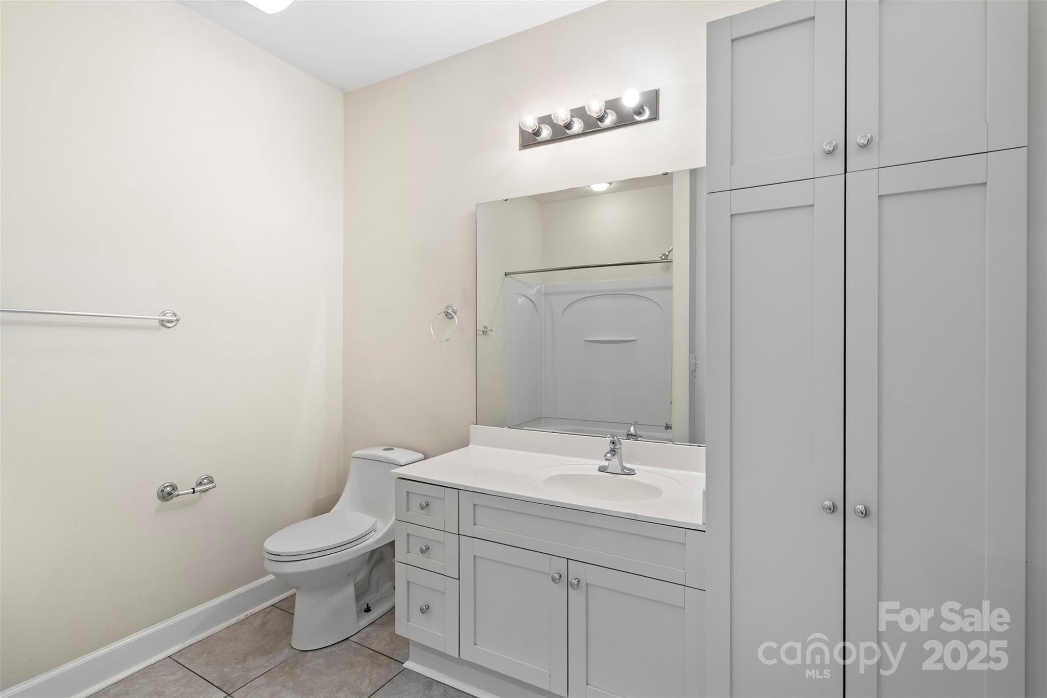 3805 Balsam Street, Unit 321 Indian Trail, NC 28079 - Photo 25 of 47 a bathroom with a sink a toilet and shower