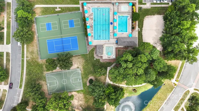 an aerial view of residential houses with outdoor space and trees