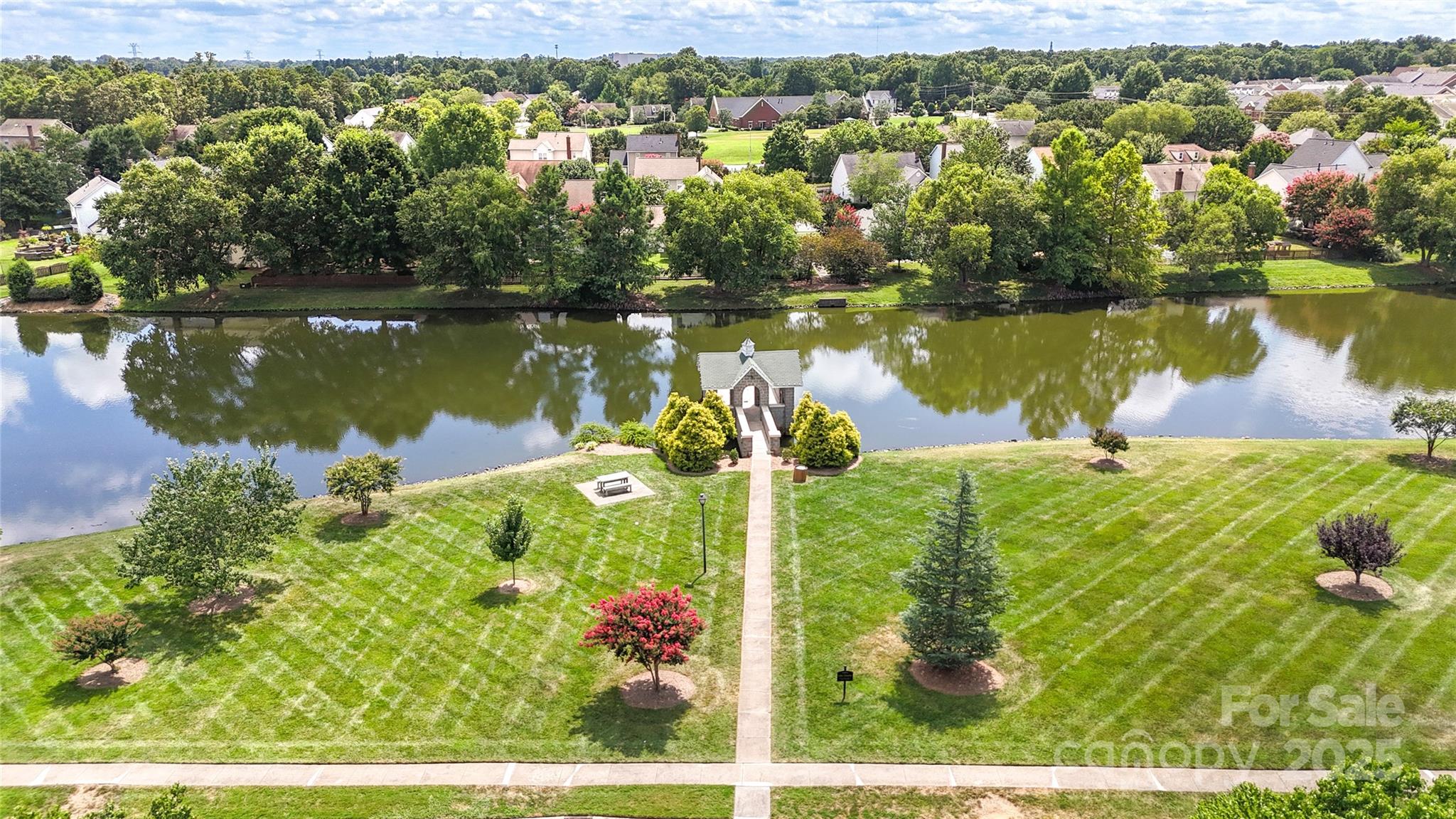 3805 Balsam Street, Unit 321 Indian Trail, NC 28079 - Photo 35 of 47 a view of a lake with a houses