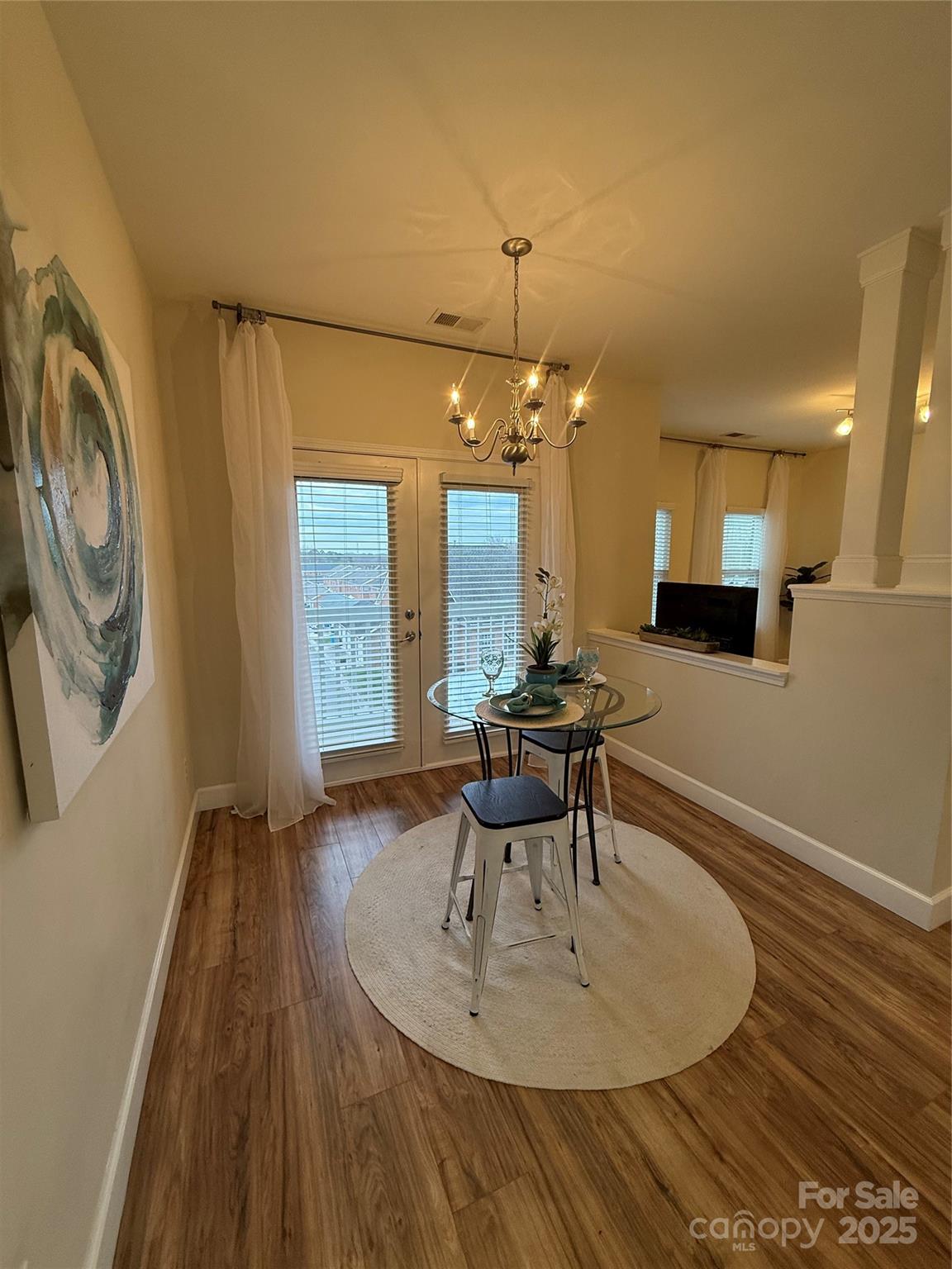 3805 Balsam Street, Unit 321 Indian Trail, NC 28079 - Photo 41 of 47 a dining room with wooden floor and a chandelier