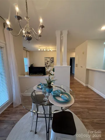 a kitchen with stainless steel appliances granite countertop a refrigerator a stove and a sink with wooden floor