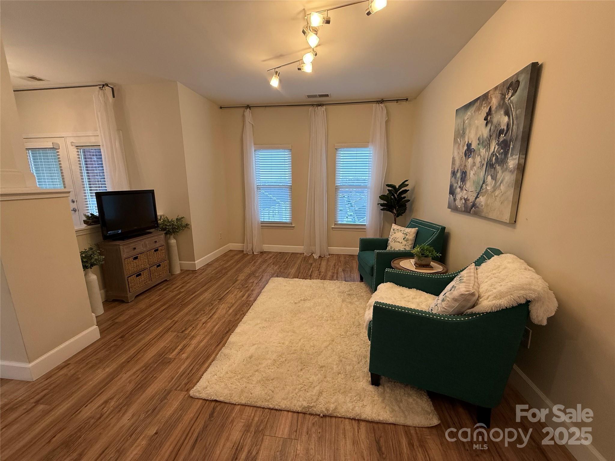3805 Balsam Street, Unit 321 Indian Trail, NC 28079 - Photo 46 of 47 a living room with furniture and a flat screen tv