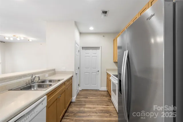 a kitchen with a sink and refrigerator