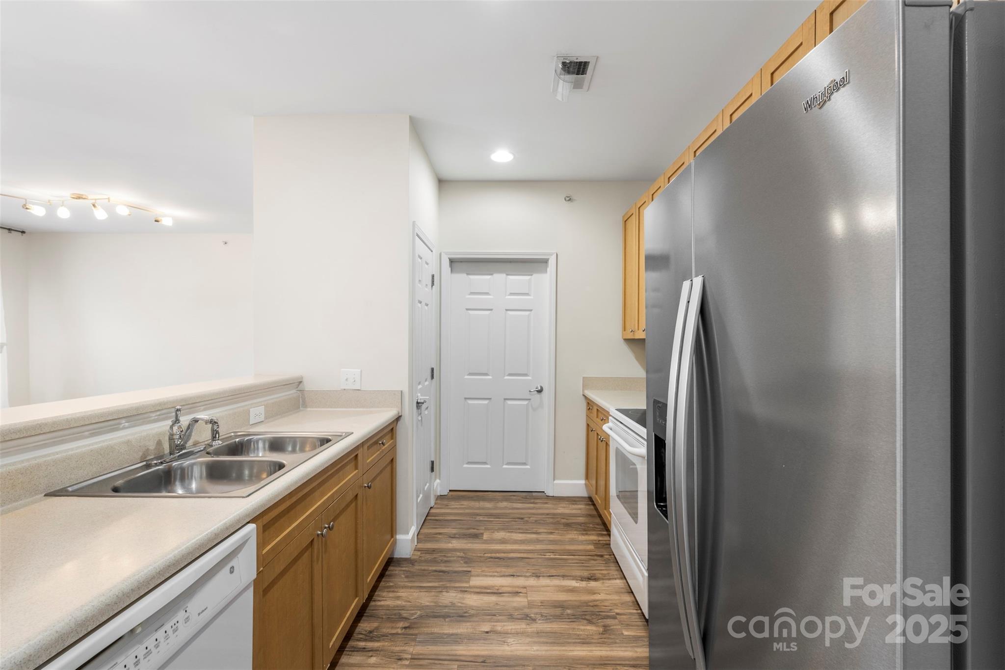 3805 Balsam Street, Unit 321 Indian Trail, NC 28079 - Photo 6 of 47 a kitchen with a sink and refrigerator