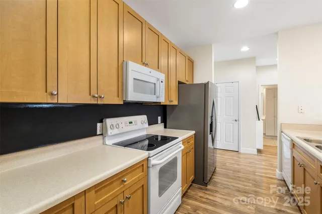 a kitchen with a refrigerator sink and cabinets
