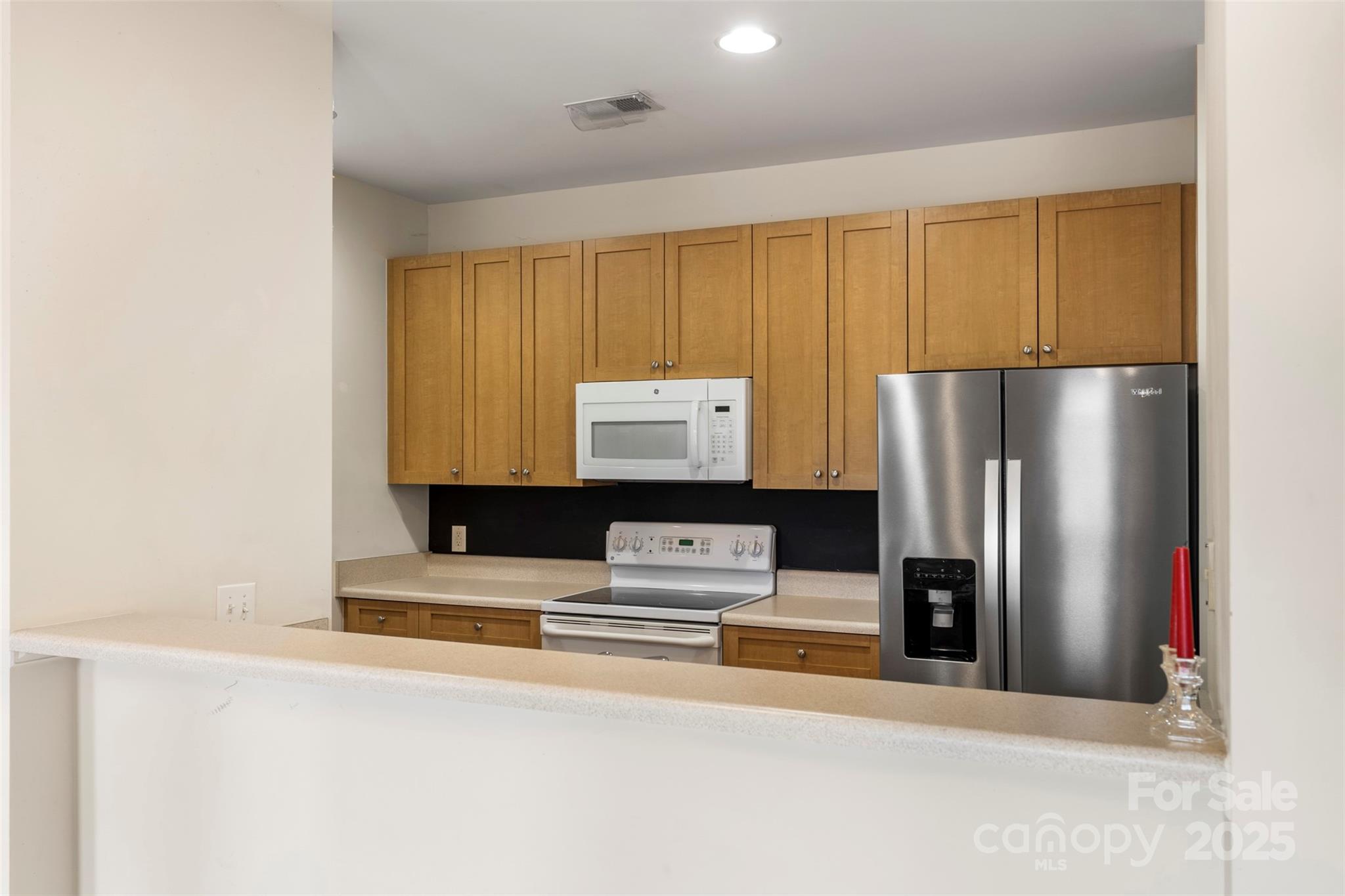3805 Balsam Street, Unit 321 Indian Trail, NC 28079 - Photo 10 of 47 a kitchen with kitchen island a counter top space cabinets and stainless steel appliances