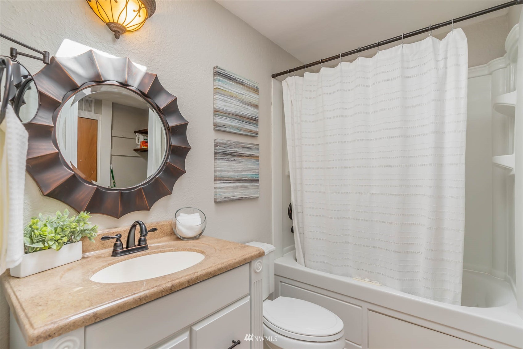 18120 19th Drive Southeast Bothell, WA 98012 - Photo 19 of 31 a bathroom with a granite countertop sink mirror vanity and a bathtub