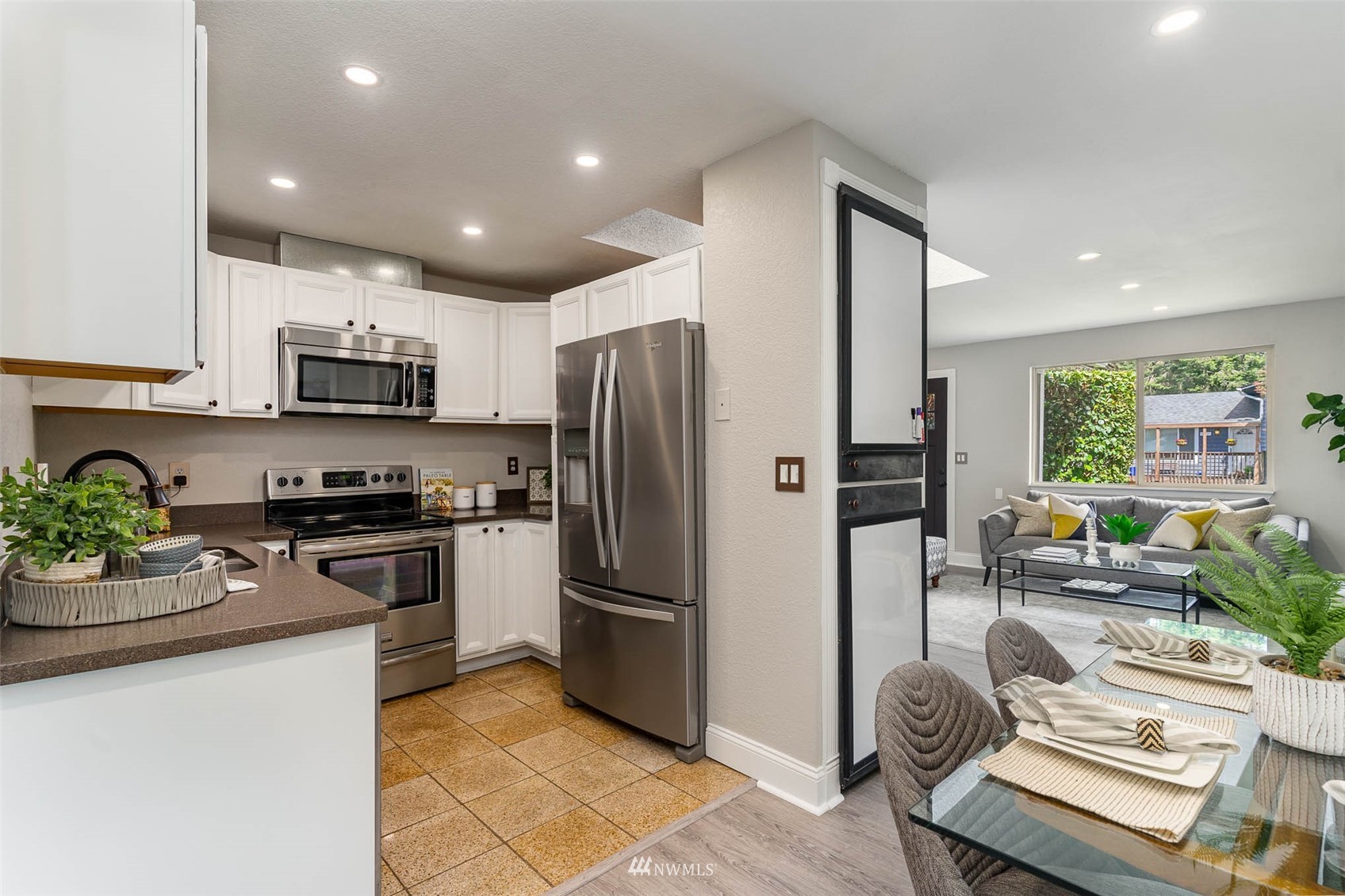 18120 19th Drive Southeast Bothell, WA 98012 - Photo 9 of 31 a kitchen with kitchen island granite countertop stainless steel appliances and a refrigerator