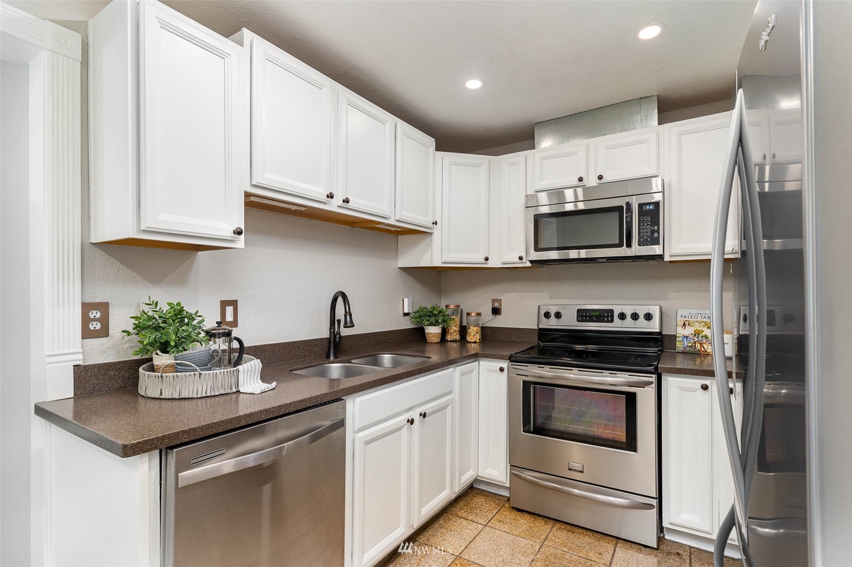 18120 19th Drive Southeast Bothell, WA 98012 - Photo 10 of 31 a kitchen with stainless steel appliances granite countertop a sink stove and microwave