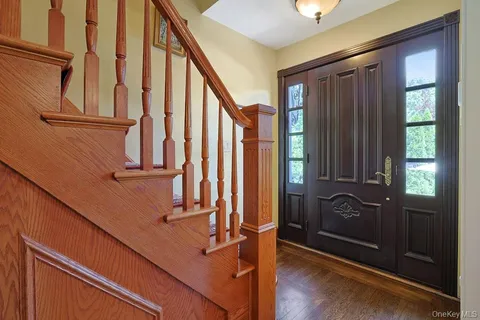 a view of staircase with wooden floor and a window