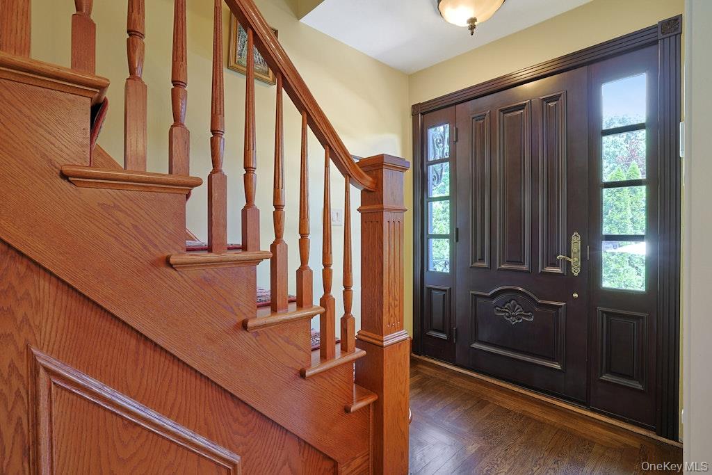 97 Underhill Road Scarsdale, NY 10583 - Photo 4 of 39 a view of staircase with wooden floor and a window