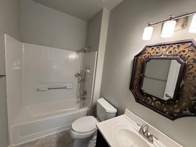 275 Bonham Loop Georgetown, TX 78633 - Photo 20 of 25 Full bath featuring vanity, a textured wall, and washtub / shower combination