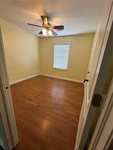 a view of a room with wooden floor