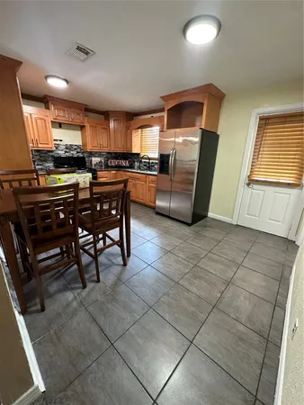 a kitchen with stainless steel appliances a sink a stove a microwave a counter top space and cabinets