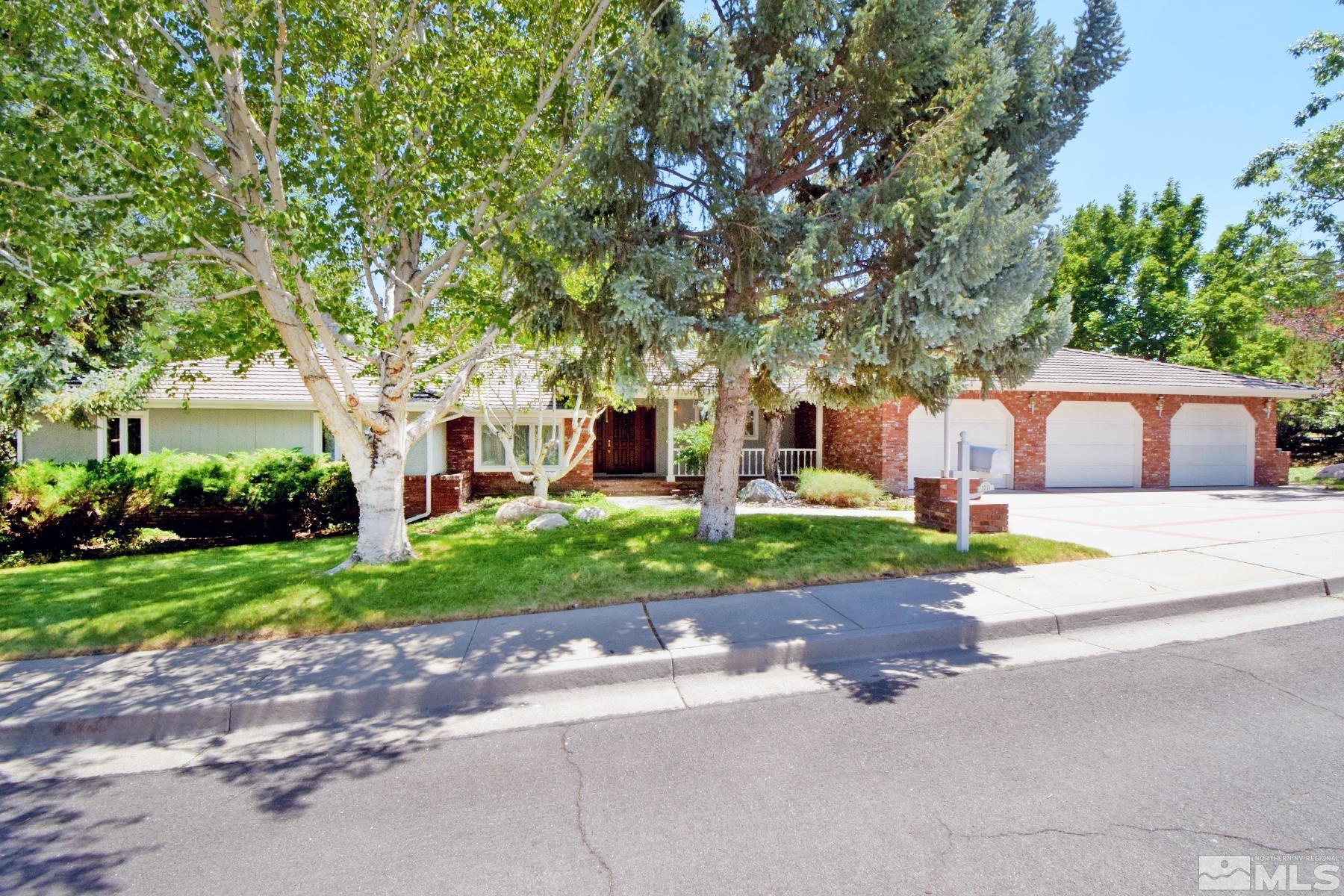 2215 Longwood Drive Reno, NV 89509 - Photo 1 of 40 a front view of a house with a yard and shrubs