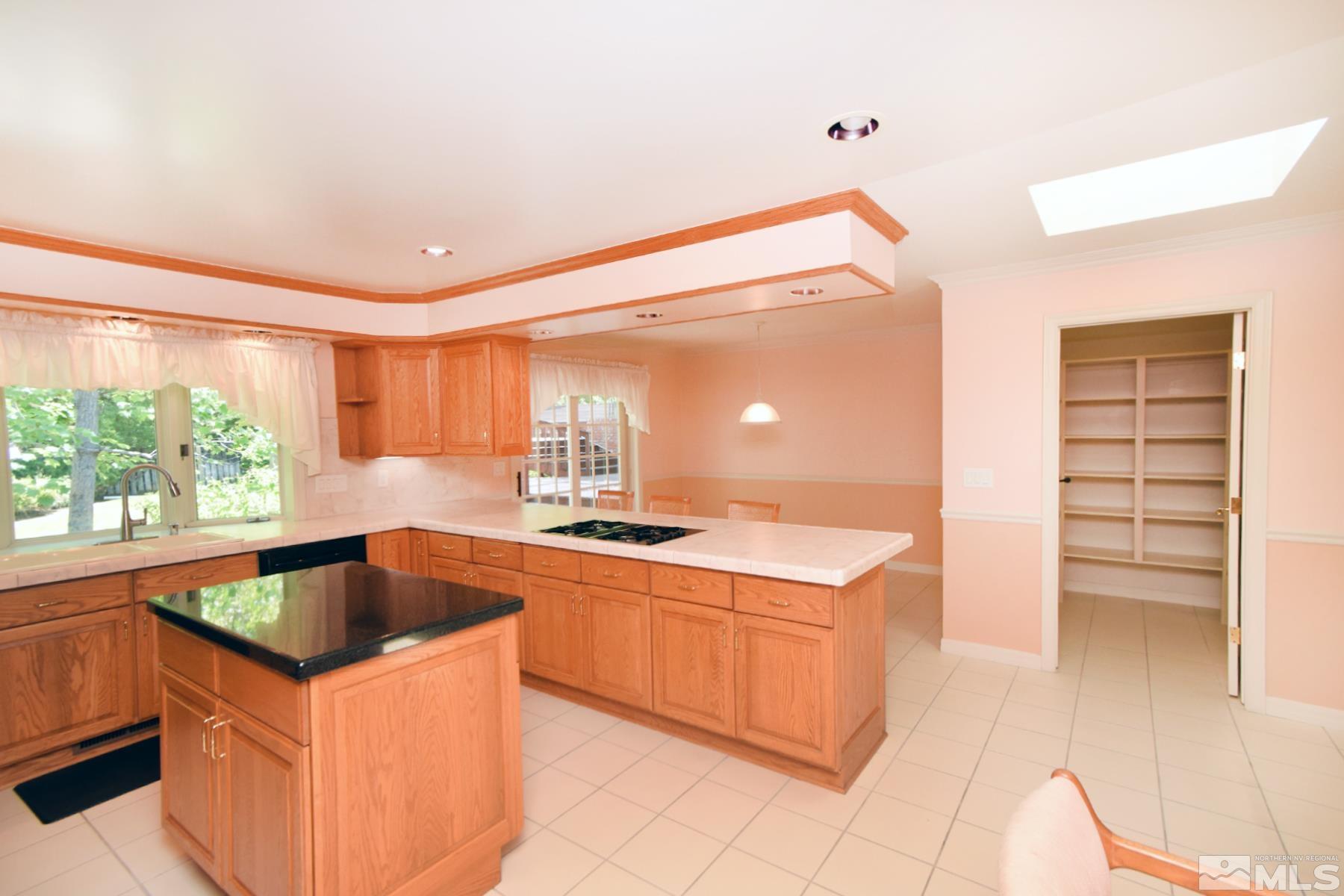 2215 Longwood Drive Reno, NV 89509 - Photo 8 of 40 a kitchen that has a sink and a stove in it
